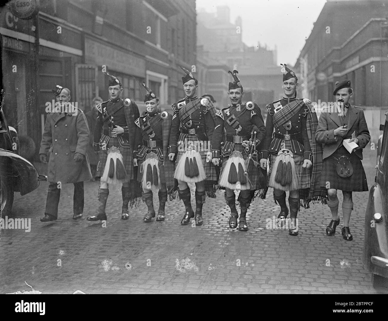 Bagpipers compete in London. The Scottish Piping Society of London are staging their sixth annual piping and dancing competition at the London Scottish headquarters, Buckingham Gate. Photo shows, bagpipers of various regiments arriving for the competition. 26 February 26 1938 Stock Photo