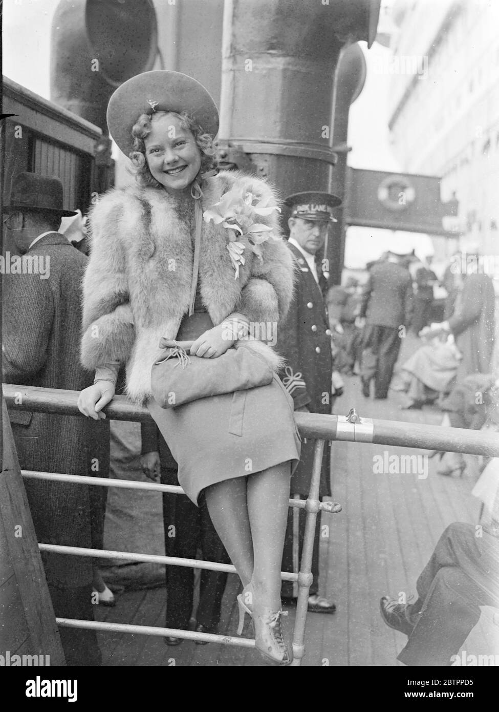Sonja Henie arrives from America. Miss Sonja Henie, the skating film actress, arrived at Southampton on the liner 'Normandie' from America. Photo shows, Sonja Henie waving on arrival at Southampton. 4 July 1938 Stock Photo
