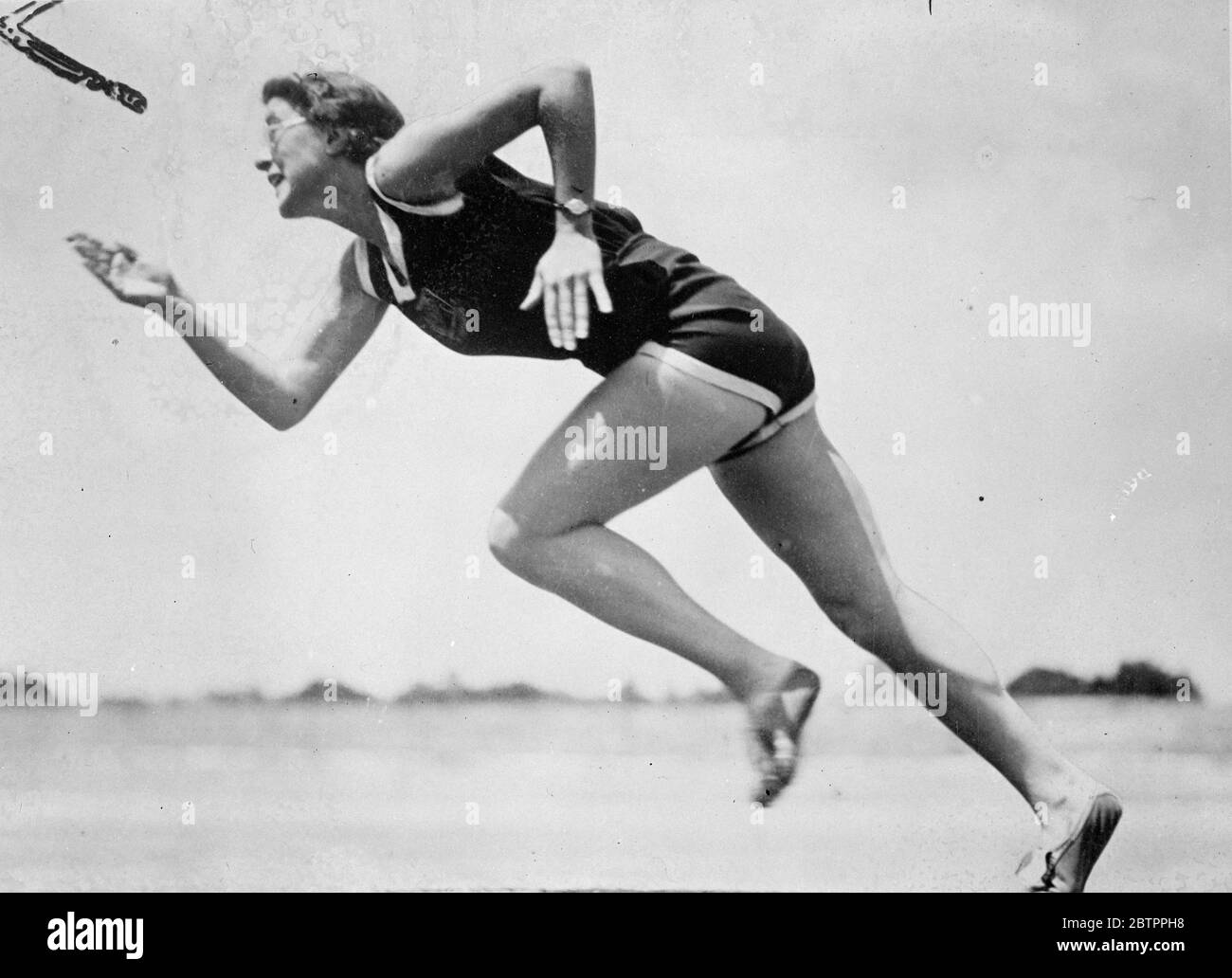 Quick off the mark. British Empire games girl practices in Melbourne. Miss M Holloway, a member of the British women's team in Australia for the Empire games to take place in Sydney, practices the 100 yard sprint in Olympic Park, Melbourne.. 26 January 1938 Stock Photo