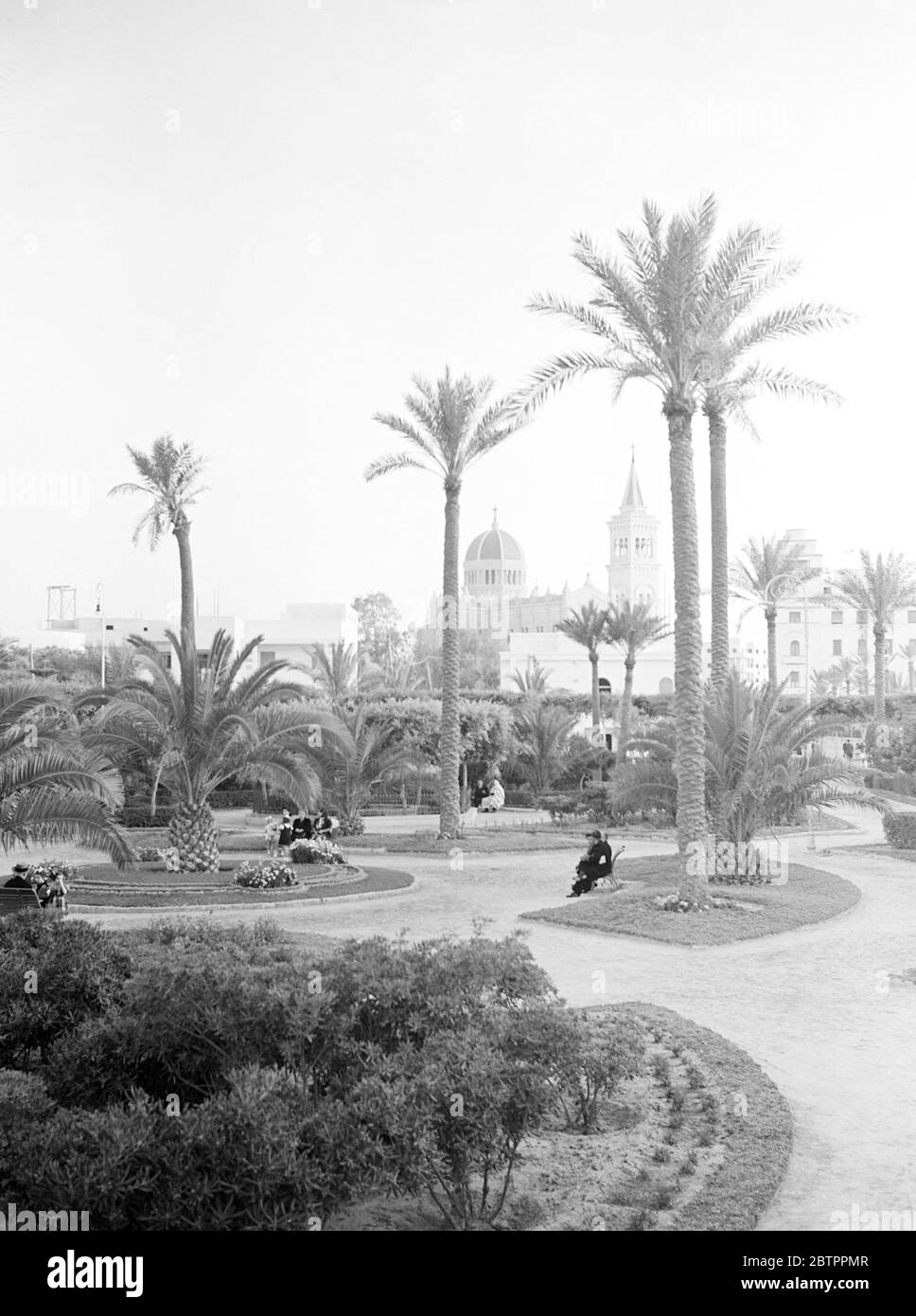 Libyan Market. The fascist salute, every evening at sunset, the life of the busy town stops dead for a minute. A gun show announces to the population the hauing down of the Italian Colours from the top of the castle of Tripoli. Stock Photo