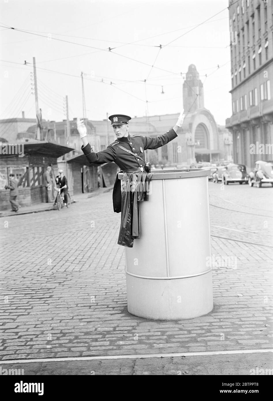 Helsinki and personalities. Policeman on point duty at Helsinki, in Heikinka tu (name of Street). In the background the railway station. Stock Photo