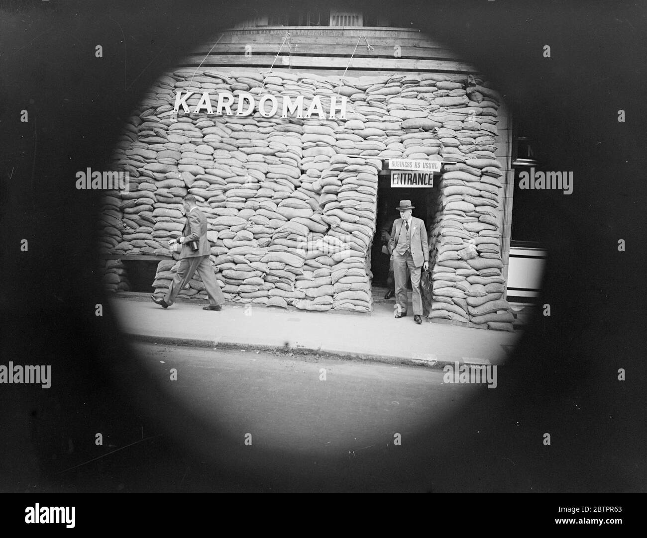 Buisness as usual. Kardomah Sand bagged front window. The photograph was taken through a spy hole as people using cameras ran the risk of being arrested. Stock Photo