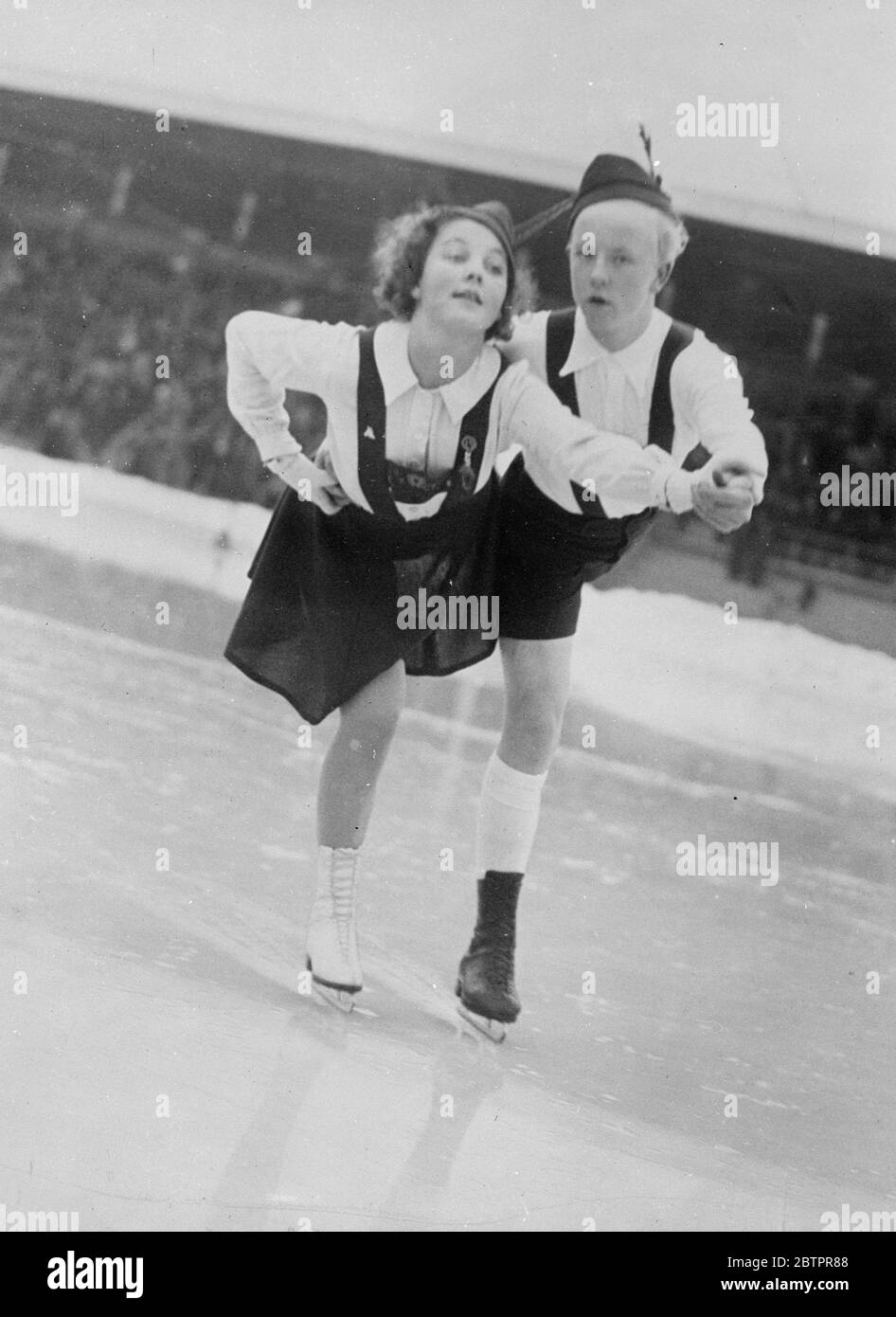 Tyrolean dance on the ice. Gunnel Ericsson (left ) and Bo Mothander, Sweden's most promising girl and boy, skaters, performing aTyrolean dance on the ice at the Stockholm Stadium, where they are training hard for the world Championships. They already hold the Swedish pair skating championship. 27 January 1938 Stock Photo