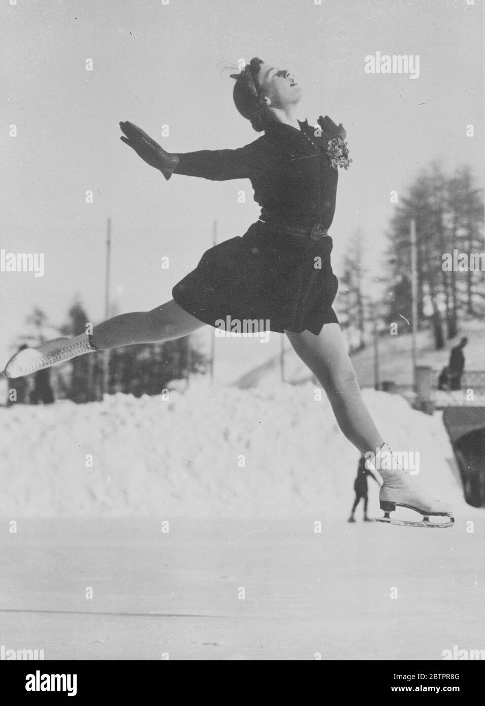 Light as air. Miss Megan Taylor, the British figure skater makes a graceful challenge to the force of gravity as she trains at St Moritz, Switzerland, for the European Championships. 19 January 1938 Stock Photo