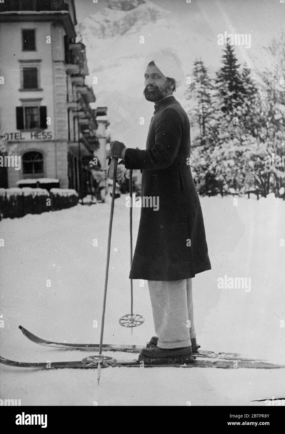 Turban and skis in Switzerland. The turban is more fitting for the blazing suns of India, than the snowy heights of Switzerland, but in this picture Mueenddin Chulan of Lahore, India, retains the costume peculiar to his country as he sets out for a day's skiing in the Engelberg. 28 January 1938 Stock Photo