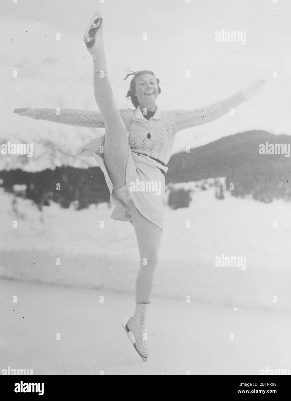 Cecilia Colledge kicks high. Preparing for European figure Skating Championships at St Moritz. Leading figure skaters from all over Europe, including Cecilia Colledge, the British holder of the world title, are now in training at St Moritz, Switzerland, for the forthcoming European Championships. Photo shows, Cecilia Colledge in a gay moment on the ice at St Moritz. 18 January 1938 Stock Photo