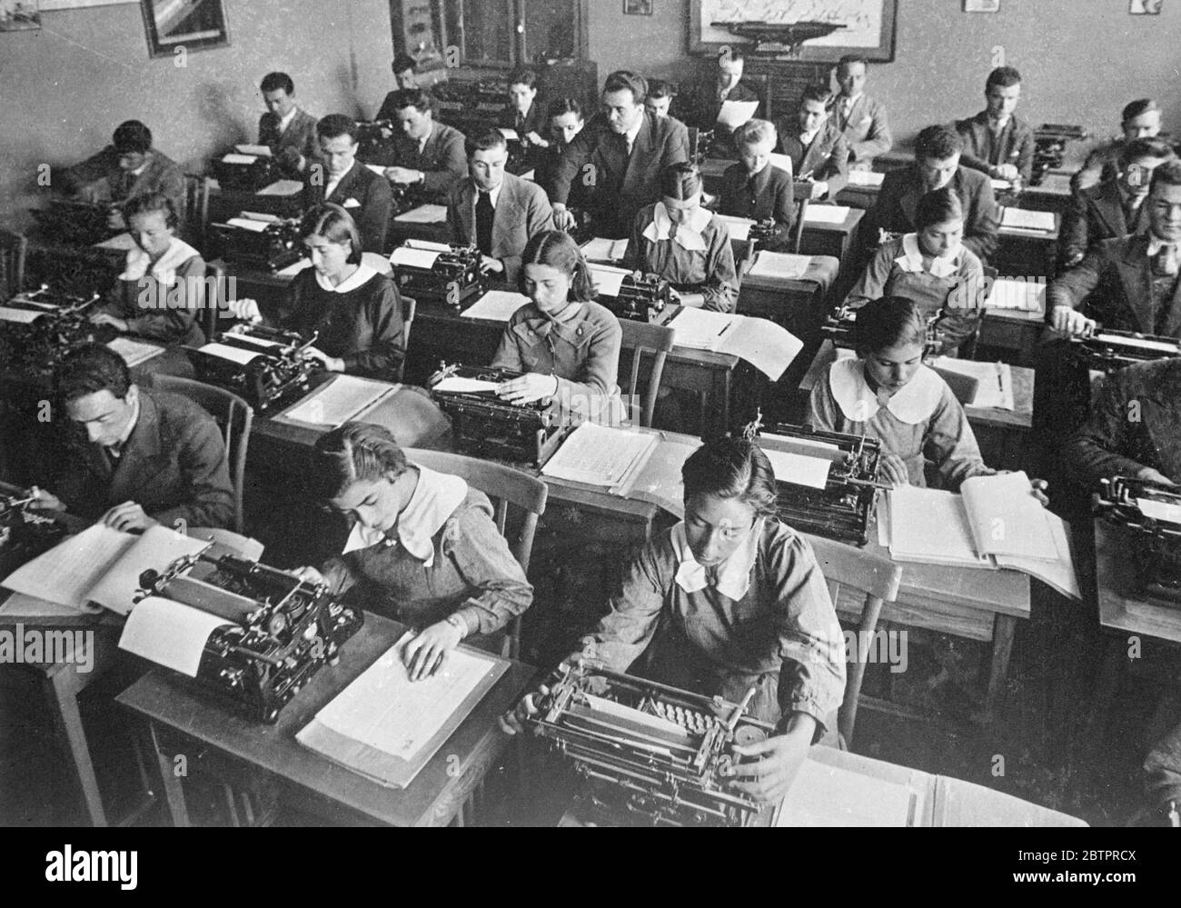 Young Turkey trains for business. Young men and women learning to operate typewriters at a commercial Institute in Ankara, the capital of Turkey. Under the westernising influence of Kemal Ataturk, the Turkish dictator, Turkey is giving up the bazaar as a trading centre in favour of busy modern offices and departments stores. 8 January 1938 Stock Photo