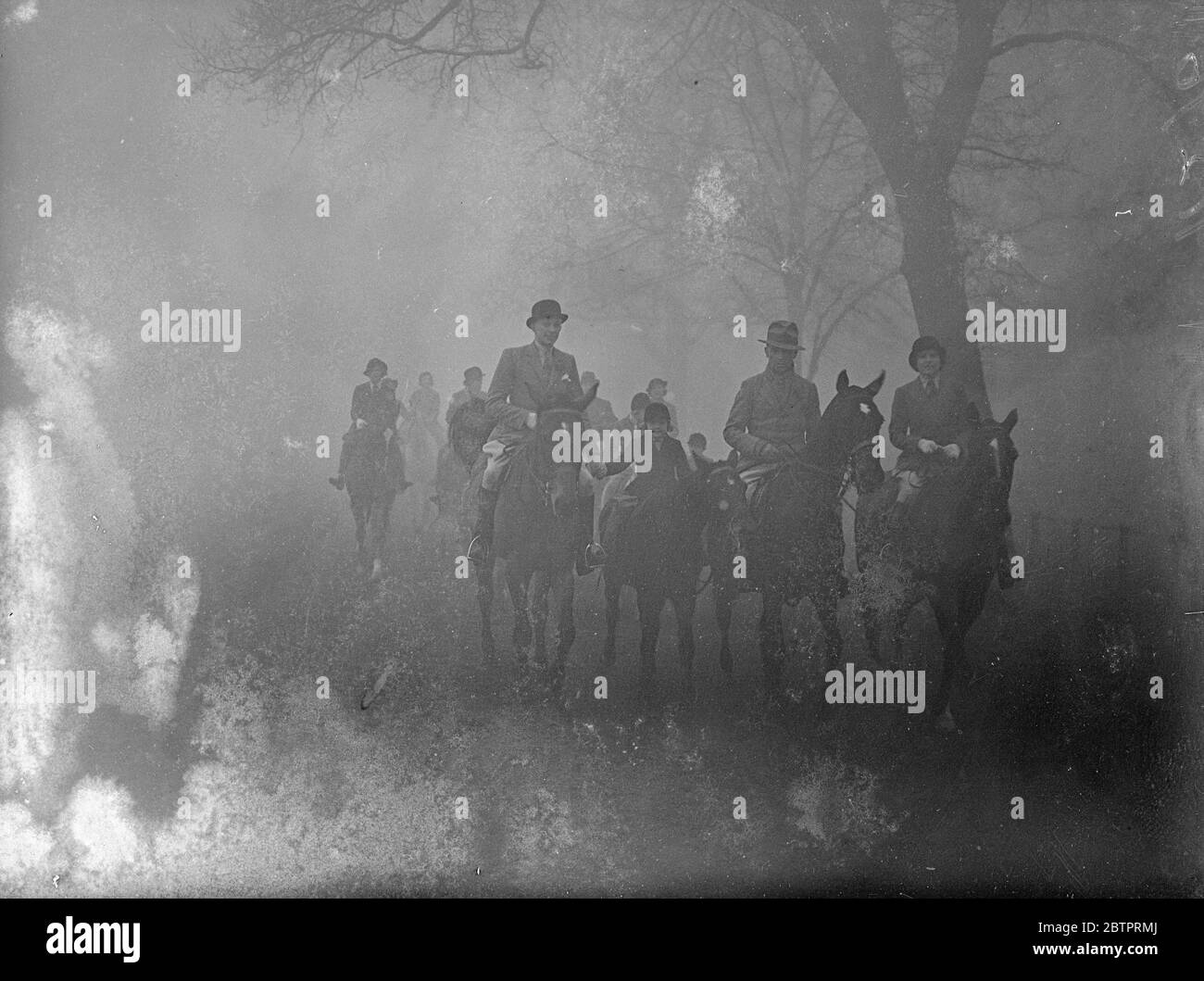 Gloomy Sunday. Frost and November fog combined could not keep riders and strollers from me Row in Hyde Park today (Sunday). Photo shows, riders loomed through the fog in the Row today (Sunday). 21 November 1937 Stock Photo