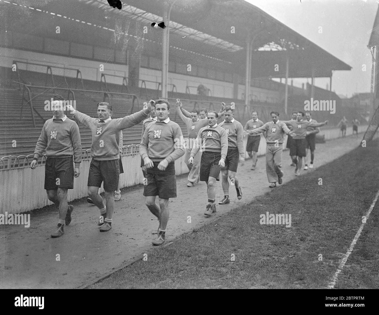 Czech footballers practice at Tottenham. The Czechoslovakian football team which is to meet England in the first international match between the two countries played in Britain, tomorrow (Wednesday), practised at Tottenham Hotspur's ground in White Hart Lane, where the match is to take place. Photo shows, Czech players exercising at Tottenham. 30 November 1937 Stock Photo