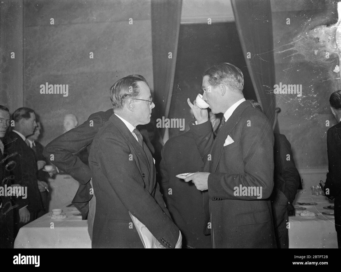 China tea?. Eden during a recess in Nine Power Conference. Finger delicately poised, Mr Anthony Eden, British Foreign Minister, reflectively drinks a cup of tea, possibly China, Germany recess in the Nine Power Conference on the Sino Japanese hostilities, at the Palais Des Academies in Brussels. 4 November 1937 Stock Photo