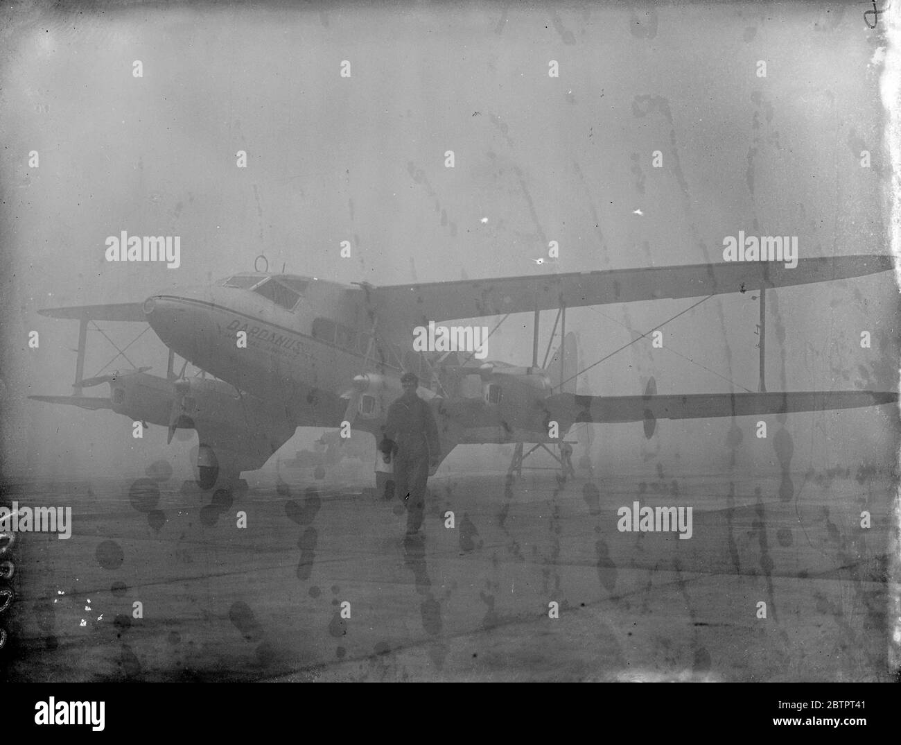 Aircraft grounded owing to fog. And imperials Airways liner De Havilland DH86A 'Dardanus' (G-ADUE) being taken into the hangar at Croydon through the fog which caused aircraft to be grounded and usual services suspended today (Tuesday). 2 November 1937 Stock Photo