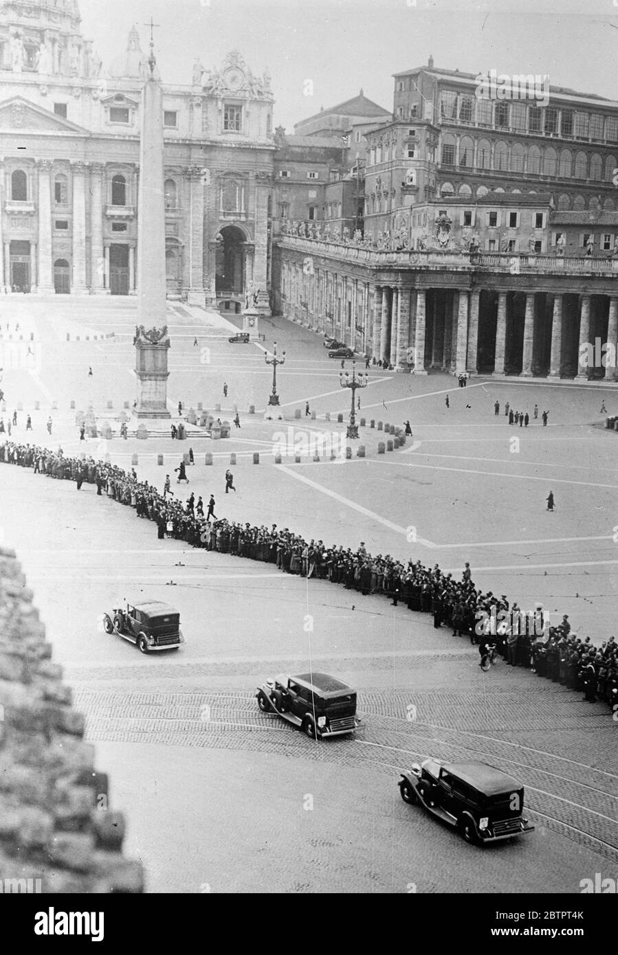 Pope returns to the Vatican. Unusual picture. An unusual picture as the Pope returned by car to the Vatican after his stay at Castel Gendolfo. Large numbers of people formed a long line across the 'Piazza'of St Peter's in the hope of seeing the Pope, who is now stated to be in fairly good health again. 3 November 1937 Stock Photo