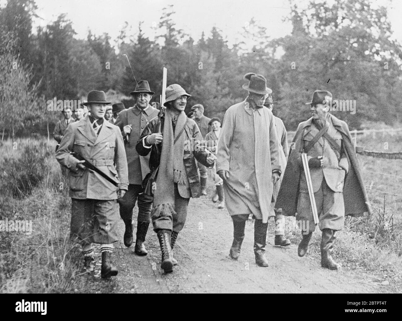 King Gustav goes hunting. King Gustav of Sweden took part in the autumn hunt at Berga, the estate of Royal Forester Helge Ax;son Johnson, near Stockholm. There was a good bag of deer, roes and hares. Photo shows, the Royal party on the way to the woods for the hunt. King Gustav is seen second from right, accompanied by Duke D'Otrante, Hjalmar Casserman and Admiral Fabian Tamm. 20 October 1937 Stock Photo