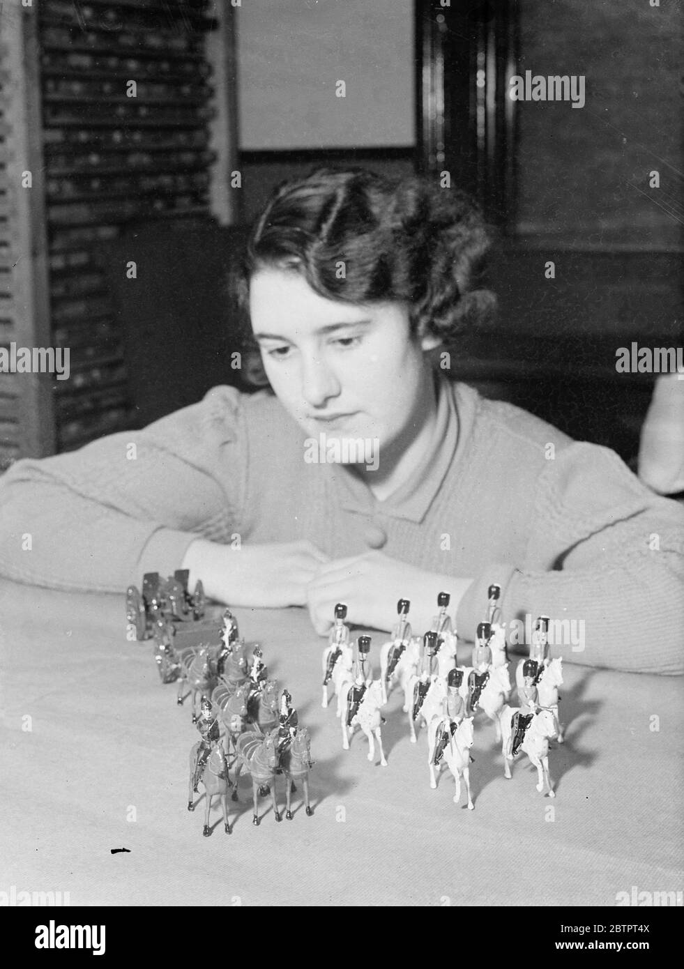 'Recruits'to Britain's Christmas army. Toy models of the Royal Artillery and Scots Greys made in a factory in Hornsey Rise, London, for the Christmas market. This year, there is an unprecedented demand for toy soldiers, perhaps as a result of the governments recruiting campaign and factories are working at full pressure. 23 November 1937 Stock Photo