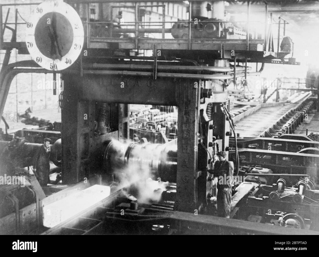 Steel mills in the USSR. Rolling ingot's at the mills in Magnitogorsk, USSR. The white hot metal is seen at left. 1930s Stock Photo
