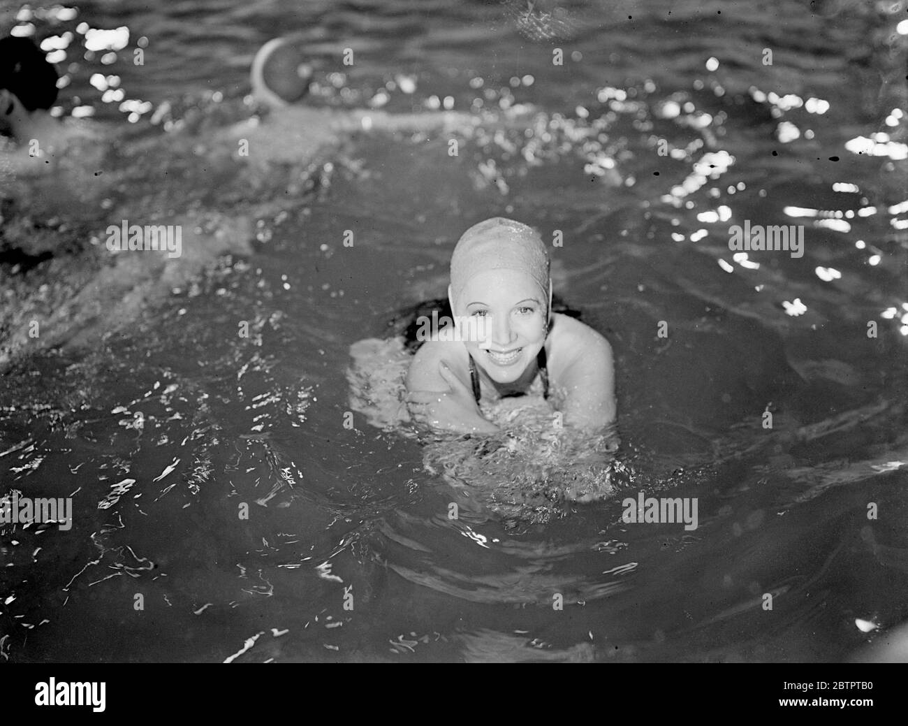 Barbara Blair, the actress, displays an I'm enjoying it smile when she takes a mid-October bathe at Elstree for the filming of Murder in Soho, a New Associated British film production. 23 October 1938 Stock Photo