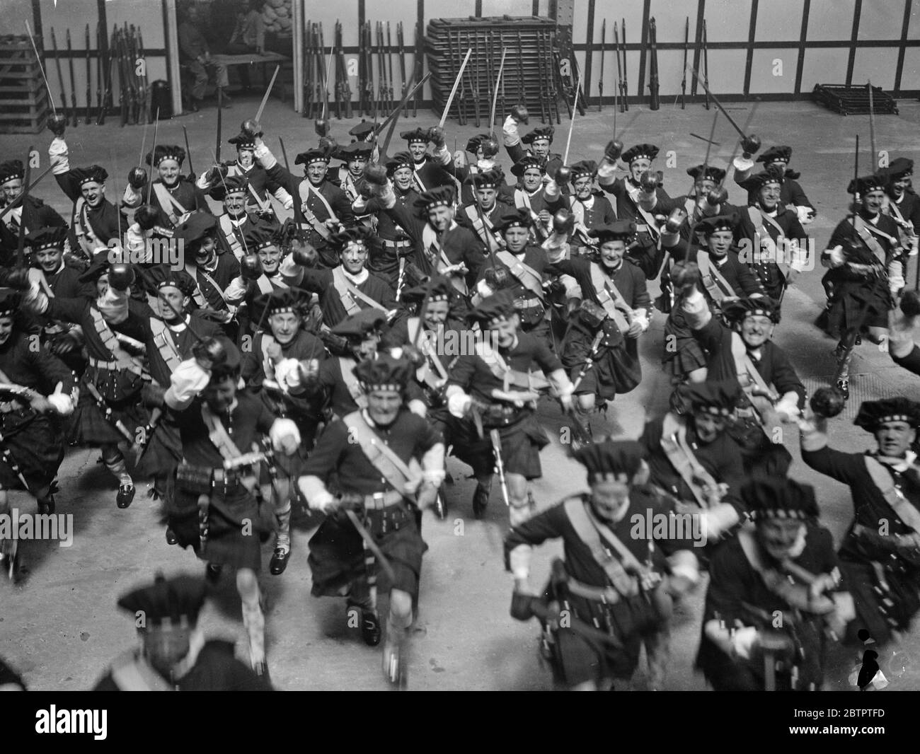Royal tournament rehearsal . Black Watch in the dress of the 1745 period rehearsing their charge for the Royal Tournament at Olympia , London , where the Tournament opens on Thursday . 14 May 1934 Stock Photo