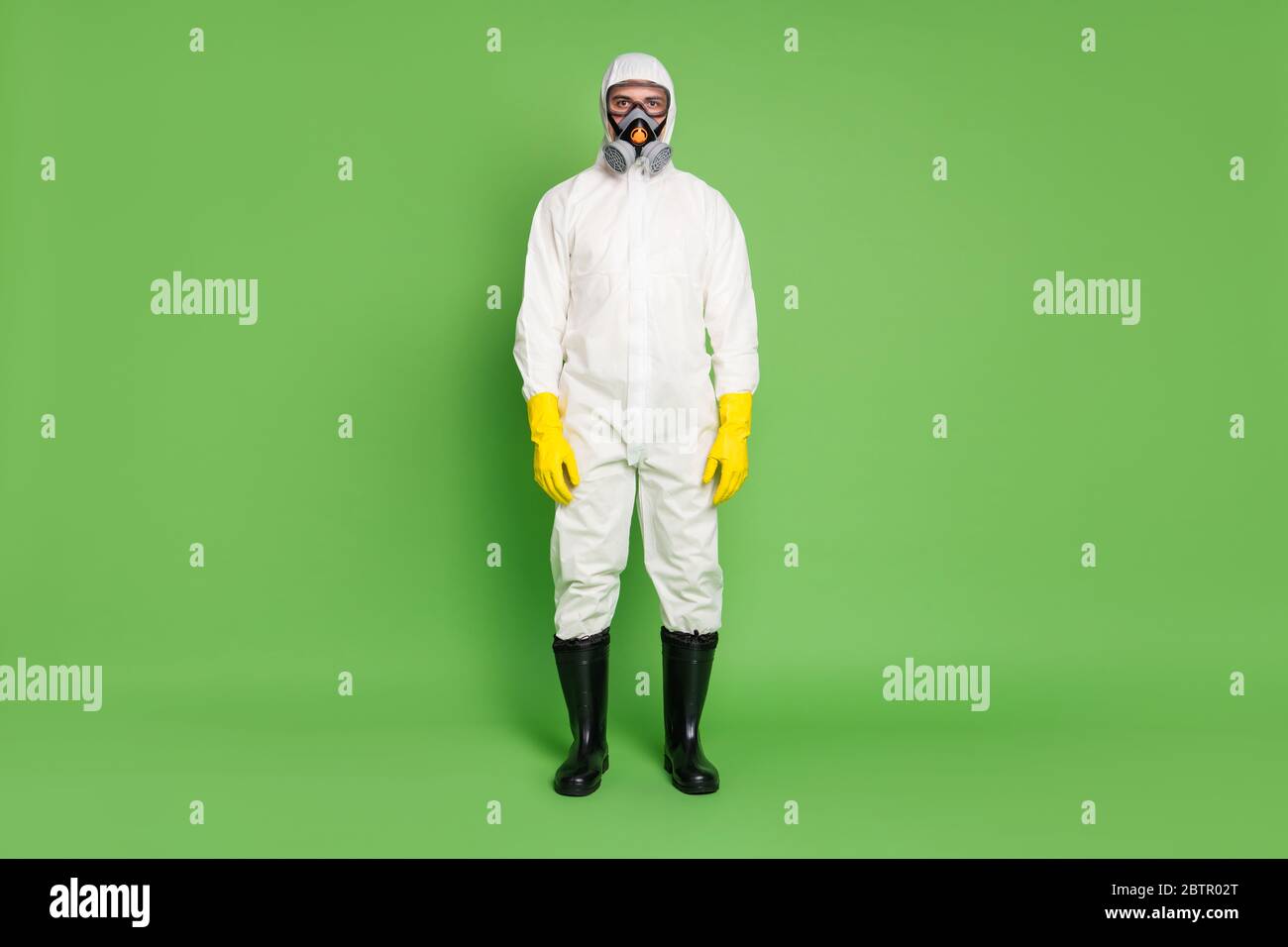 Full length body size view of his he nice serious expert workman wearing gas mask white sterile costume sars ncov n-cov-2 defense public place Stock Photo