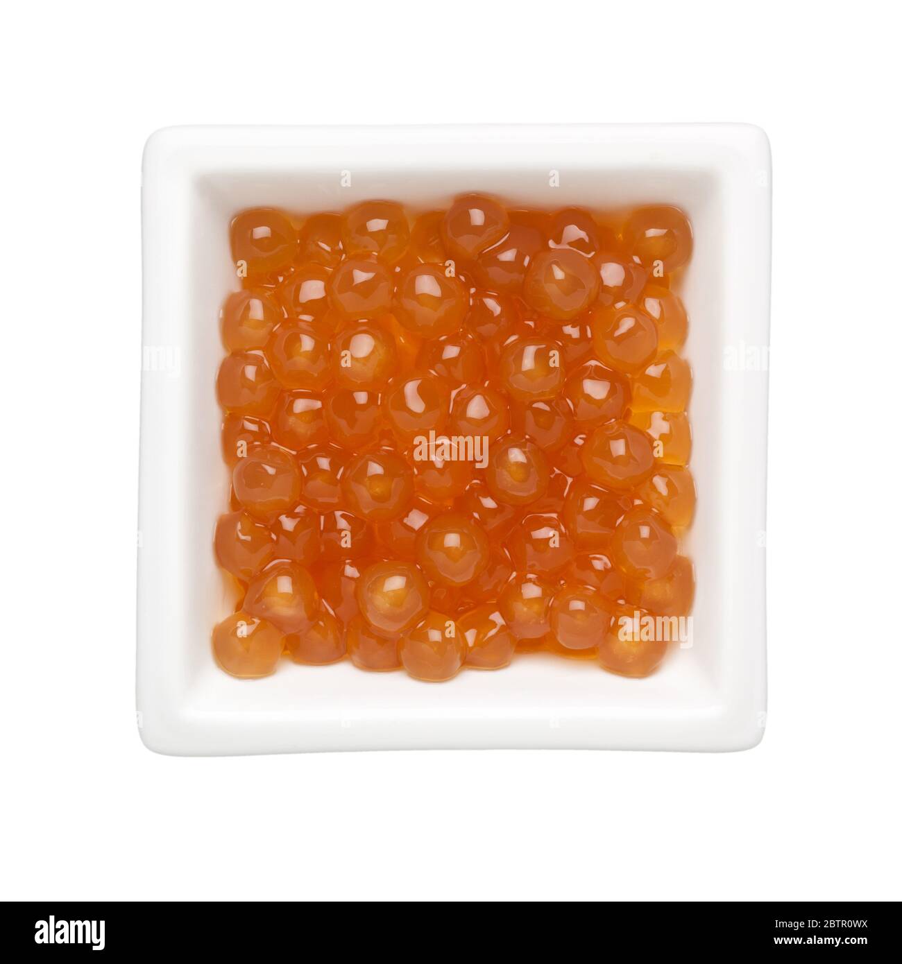 Golden tapioca pearls in a square bowl isolated on white background Stock Photo