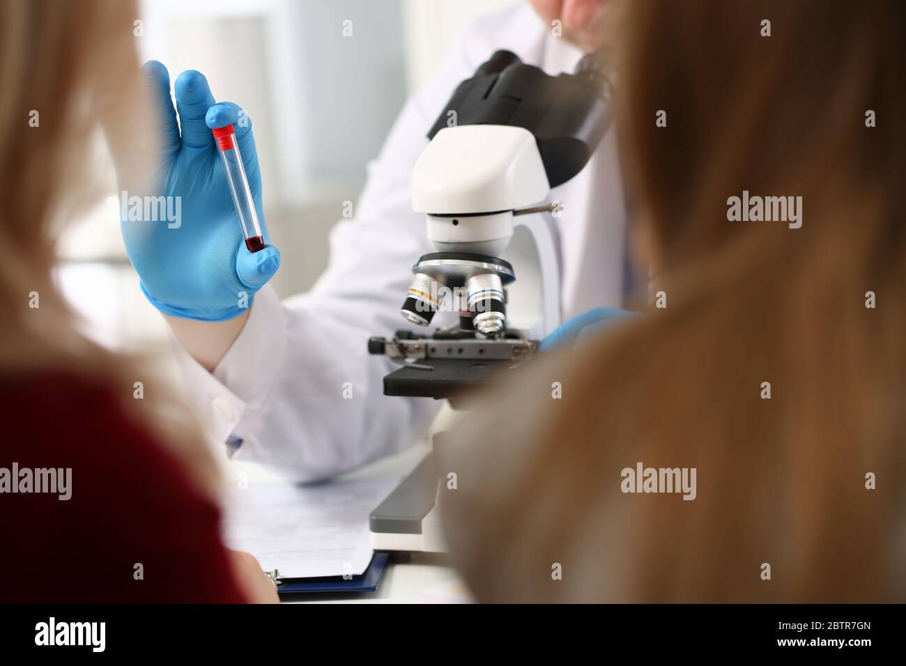 Doctor patient blood sample front microscope Stock Photo Alamy