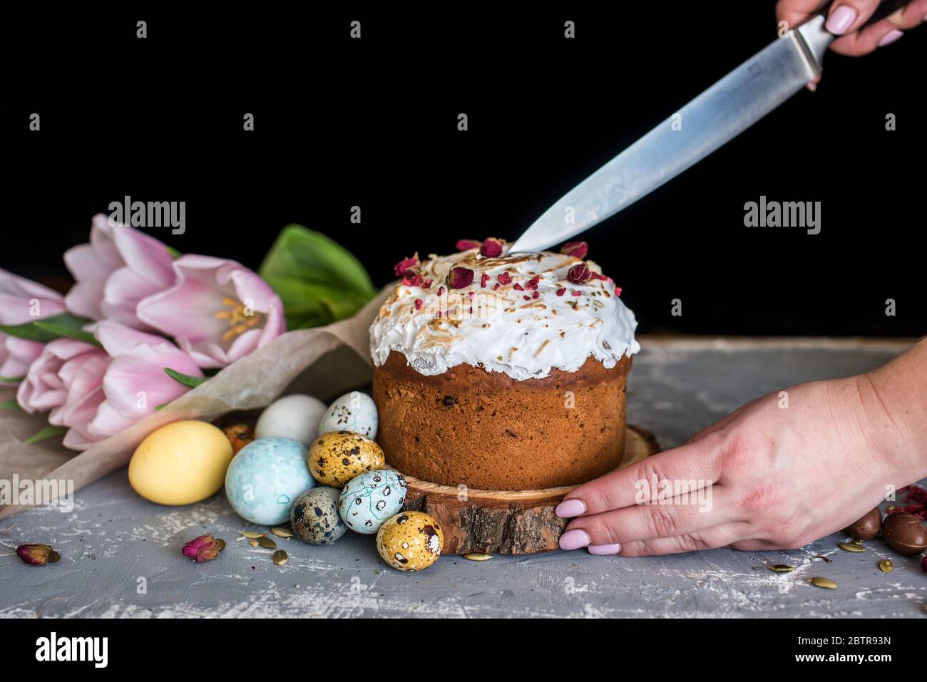 Easter composition with sweet bread, kulich and eggs on light background. Easter holidays breakfast concept. Stock Photo