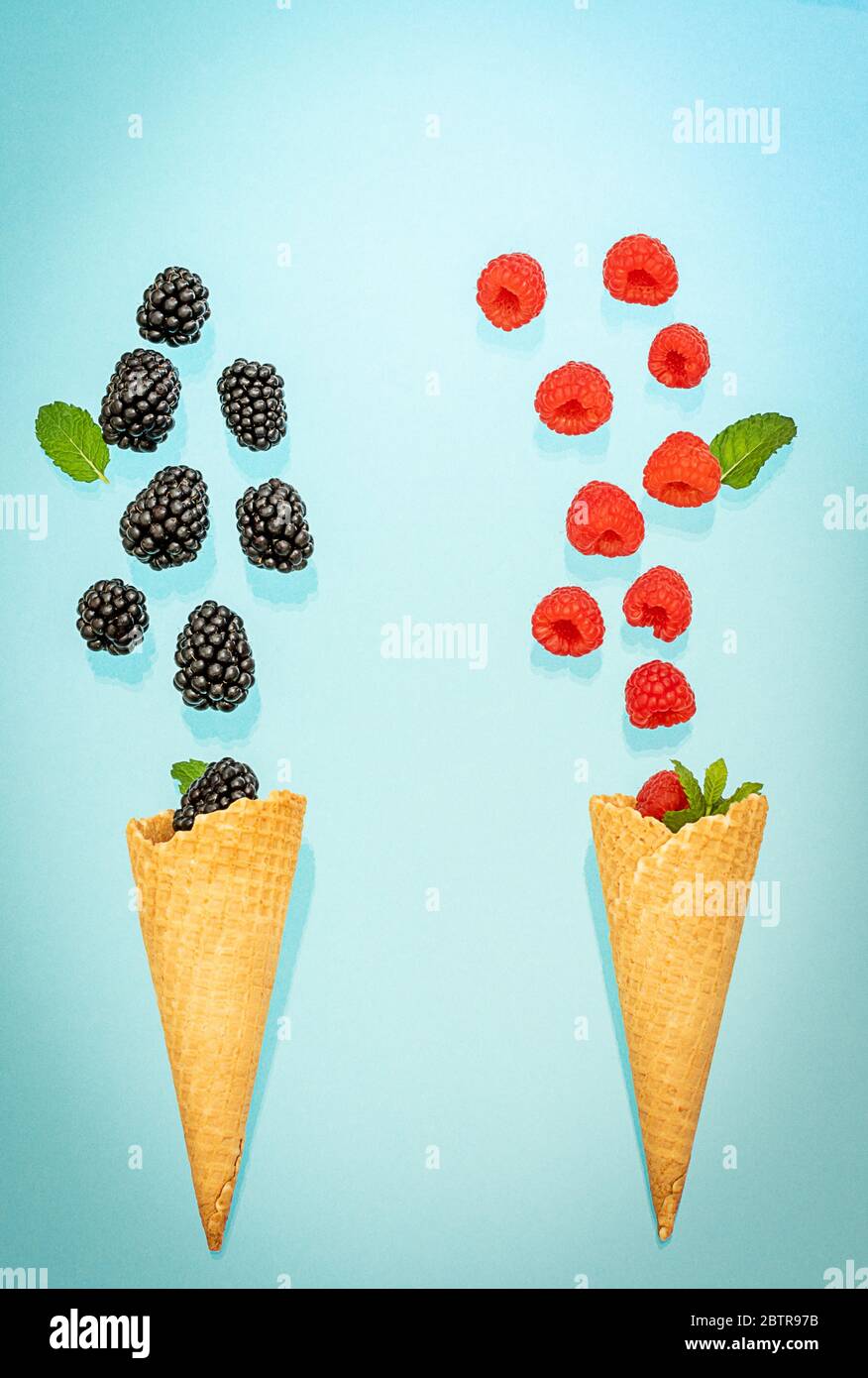 Fallen berries in two ice cream waffle cones. Summer concept Stock Photo