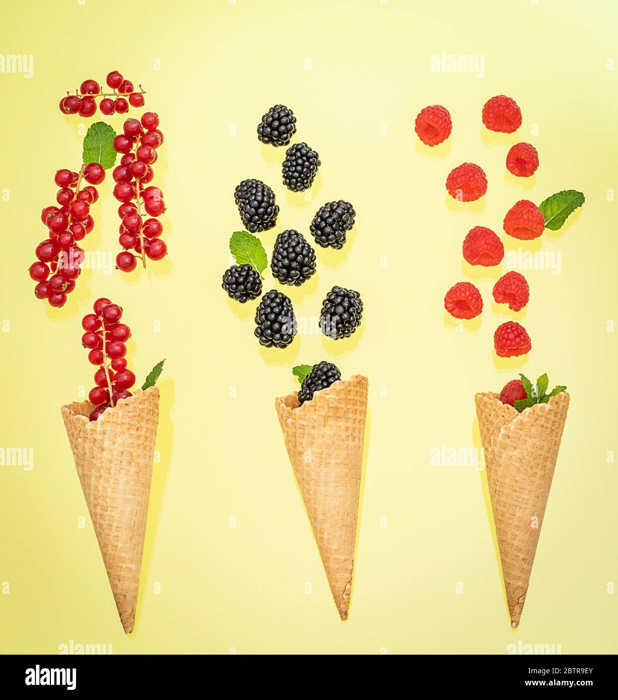 Three ice cream cones with various berries. Summer concept. Stock Photo