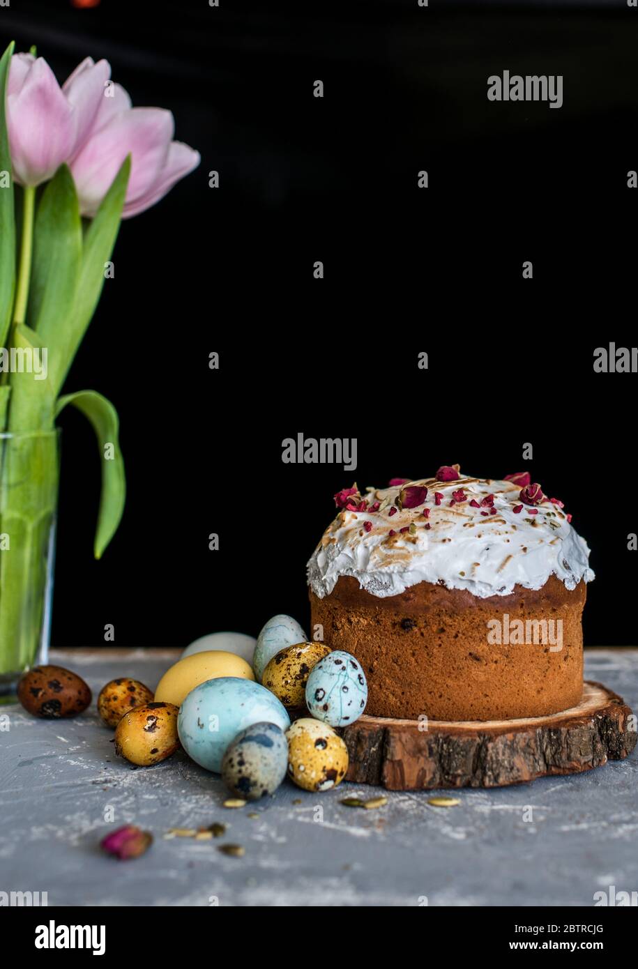 Easter composition with sweet bread, kulich and eggs on light background. Easter holidays breakfast concept. Stock Photo