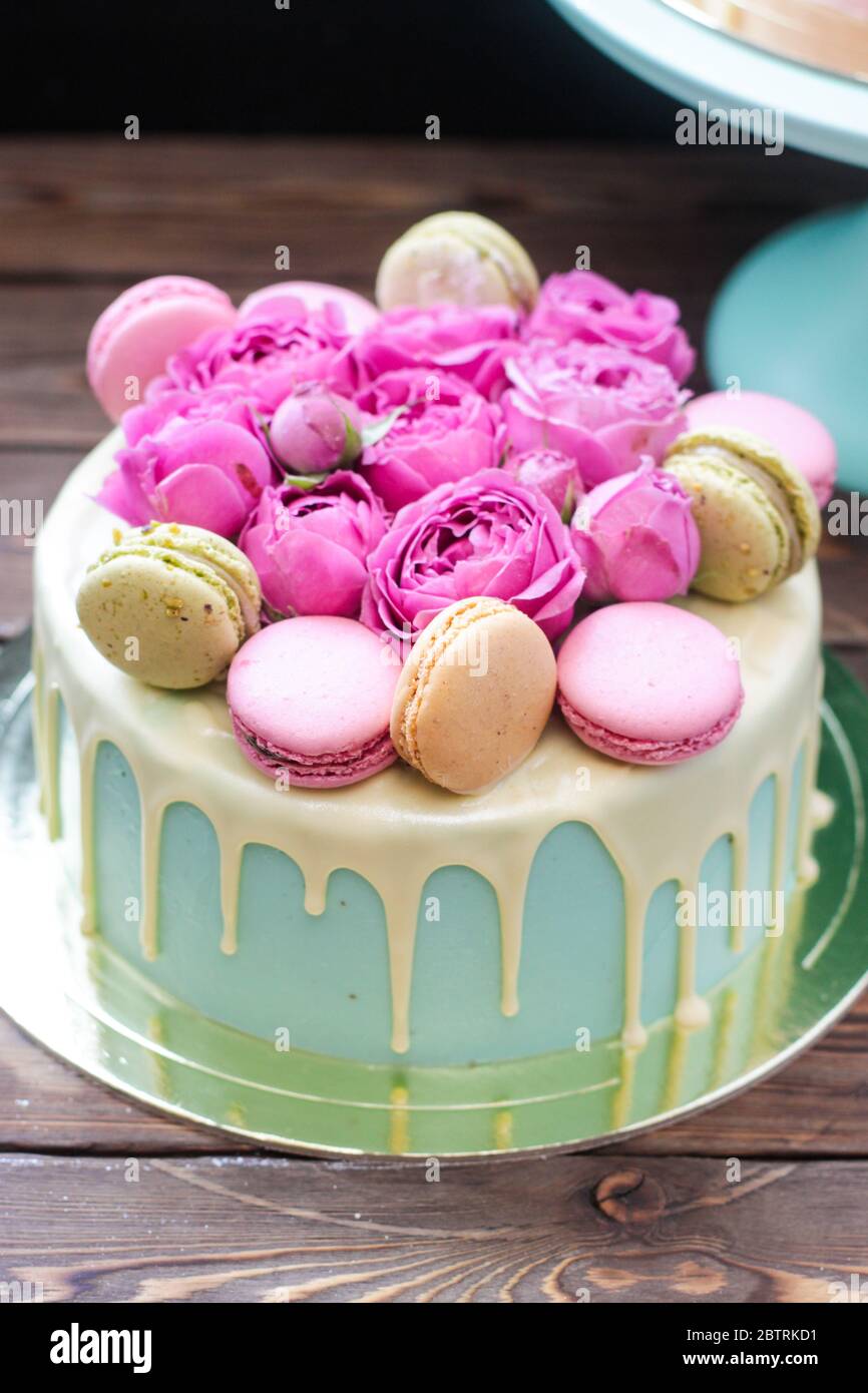 Turquoise Cake With White Melted Chocolate Fresh Roses And French Macaroons Decoration Rustic Wooden Background Stock Photo Alamy