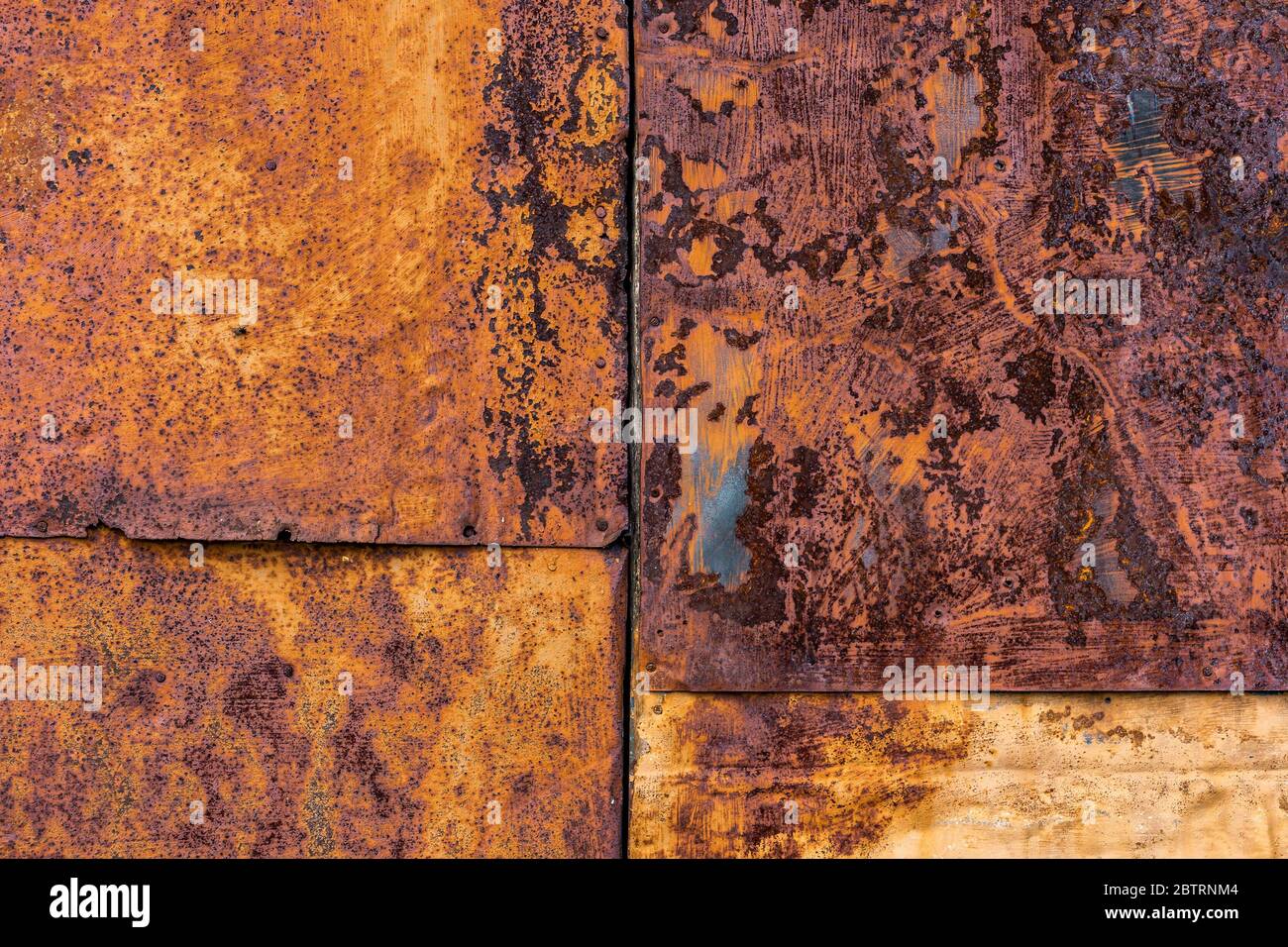 Rusted flat composite nailed metal sheets surface background and texture. Stock Photo