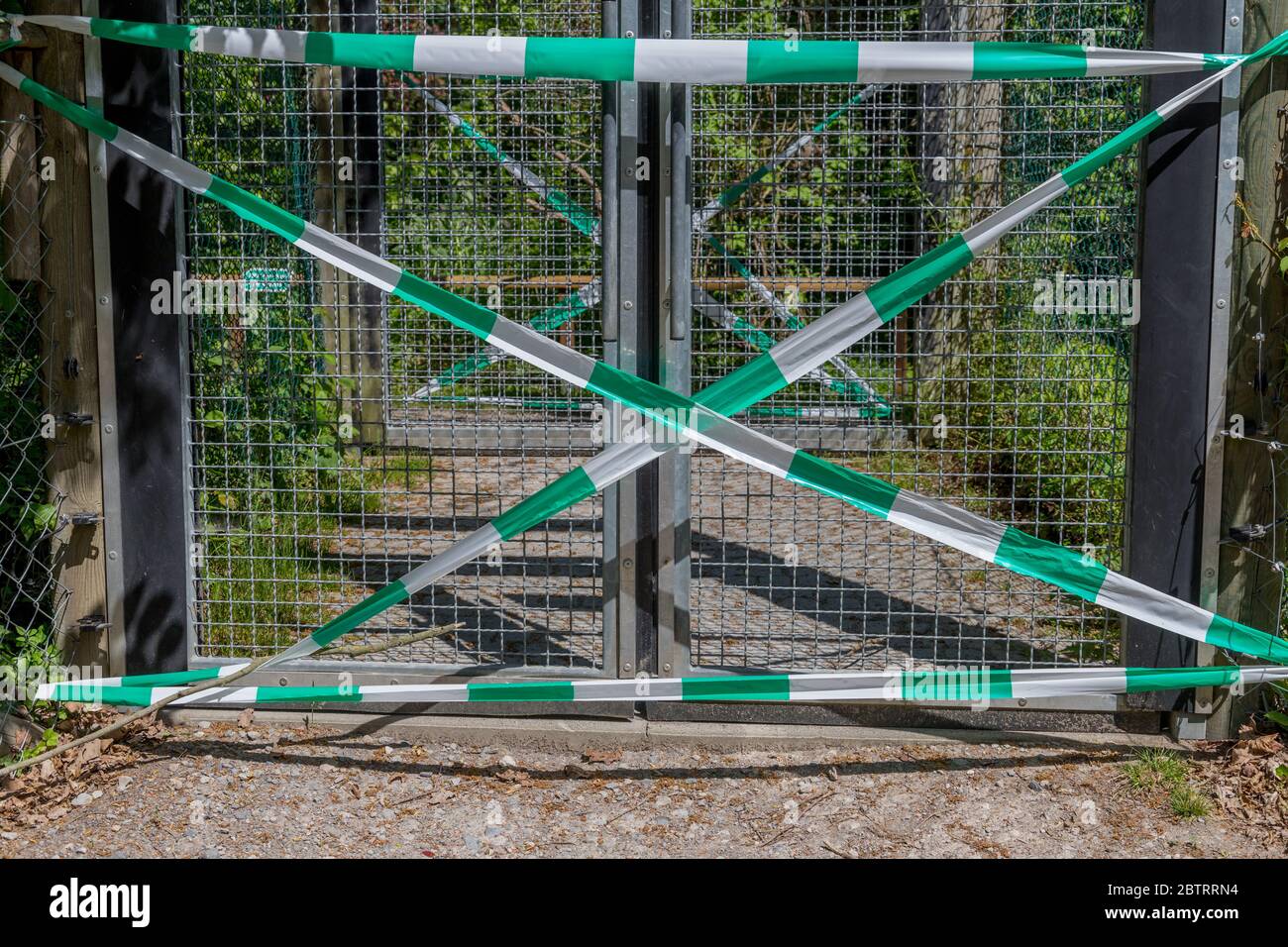 During Corona no entrance through a gate. It is closed by a barrier tape Stock Photo