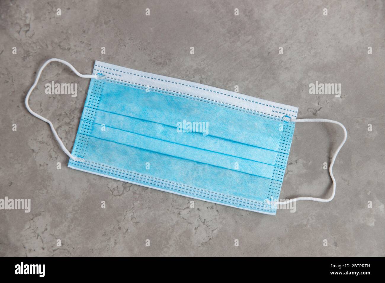 Blue medical face mask on marble table top view Stock Photo - Alamy