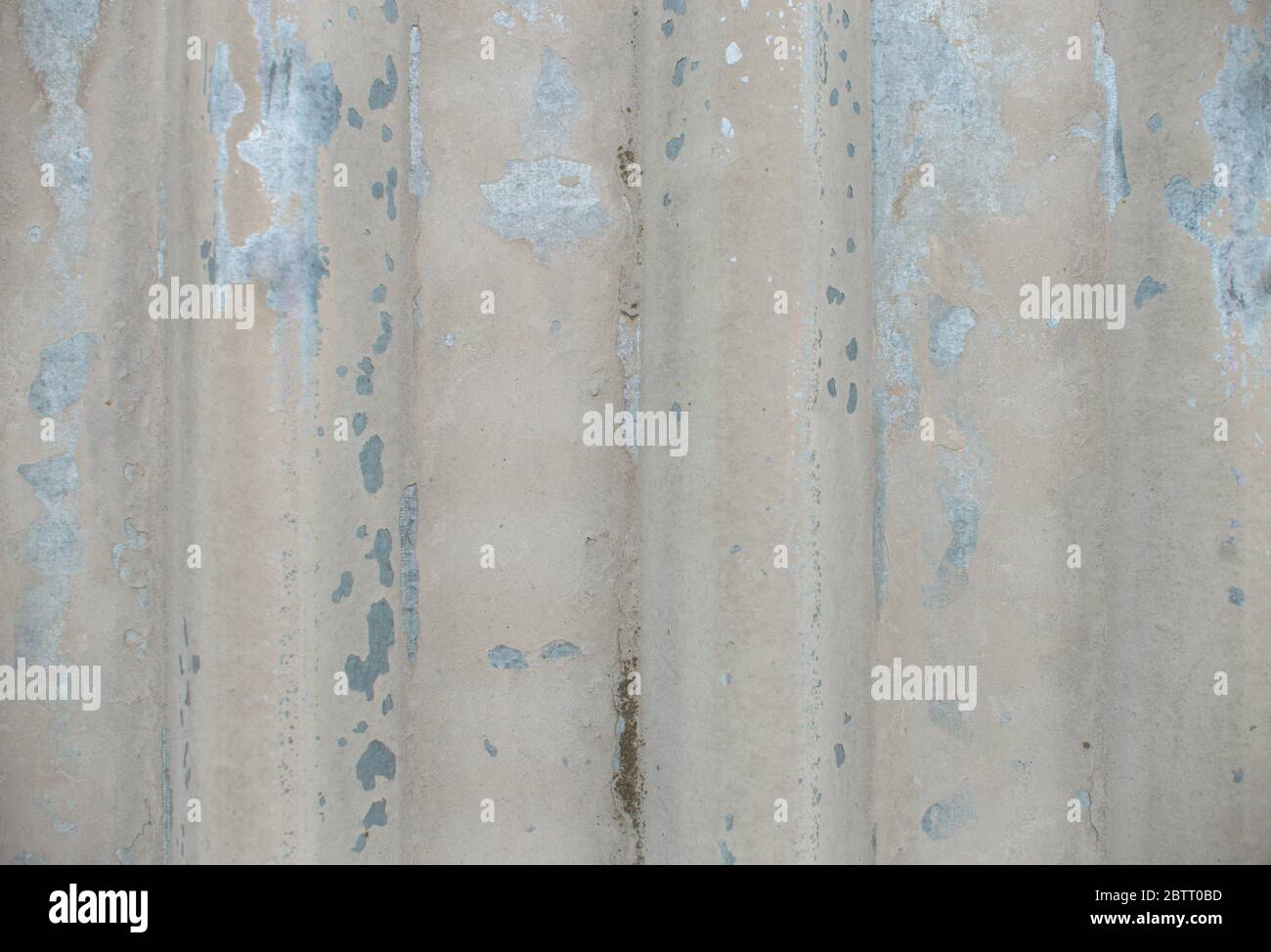 Stained corrugated galvanized iron plate texture. Peeling paint metal