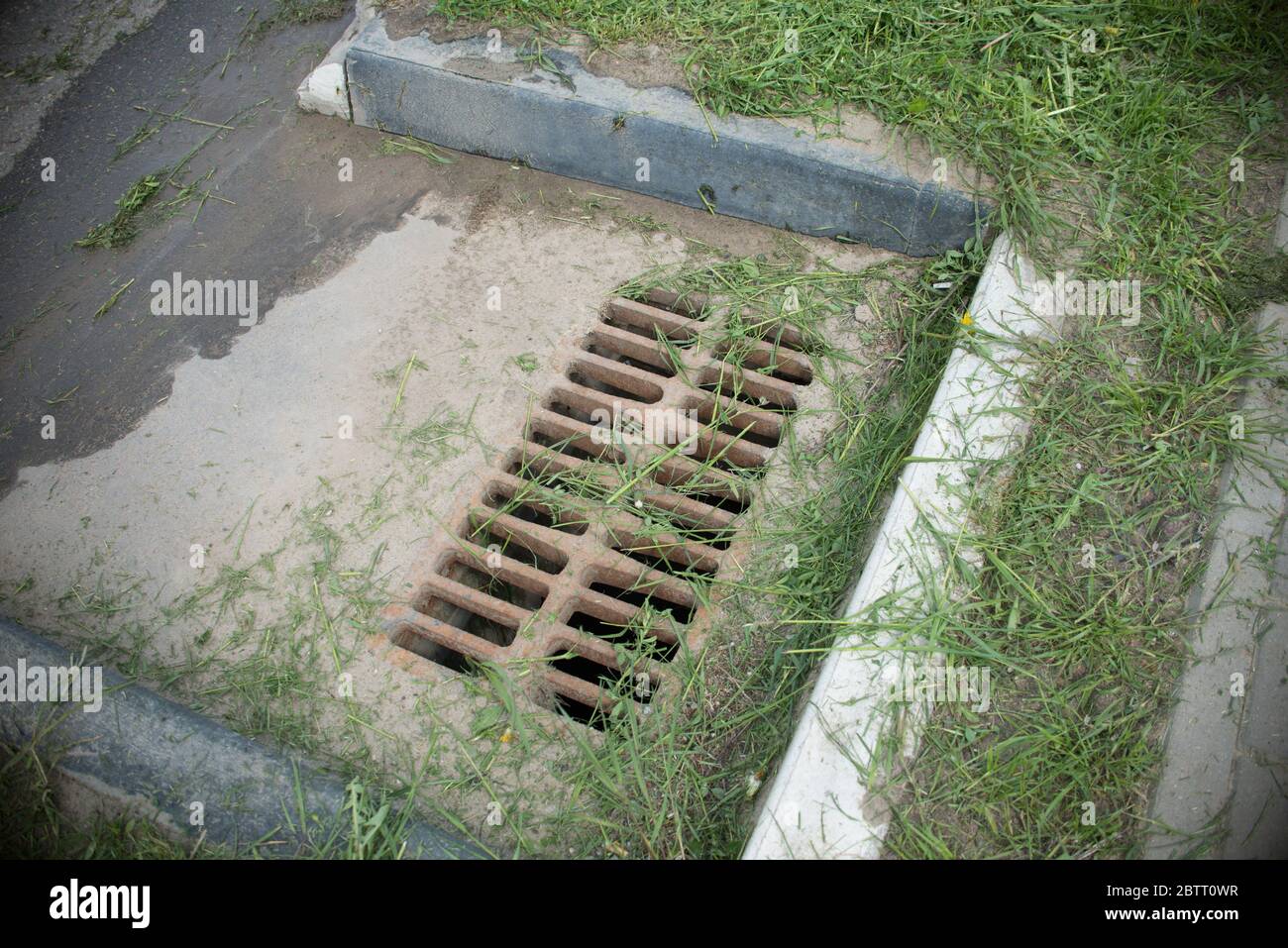 lattice storm system on the asphalt road. storm sewer on the road Stock Photo