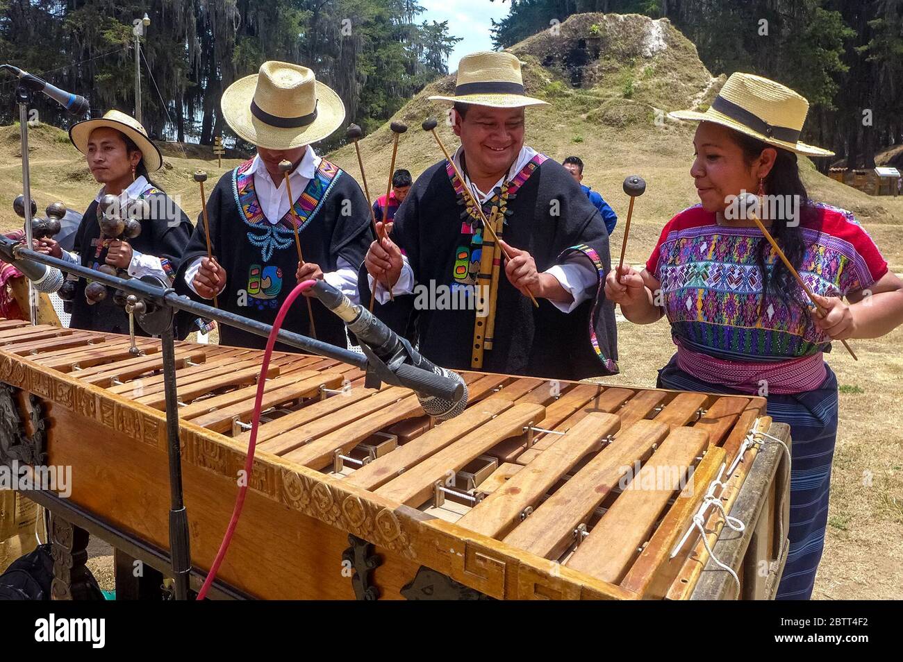 Abraham Bámaca Chalí (second from right), Ixchel Tuyuc Cux (right) and other members of Grupo Xajil, a band from San Juan Comalapa, play the marimba in Guatemala’s Chimaltenango department. The group performs ancestral music for sacred ceremonies, art circles and cultural activities around the world. The name Xajil, in the Mayan Kaqchiquel language, translates to dancing musician.(Norma Bajan Balan, GPJ Guatemala) Stock Photo