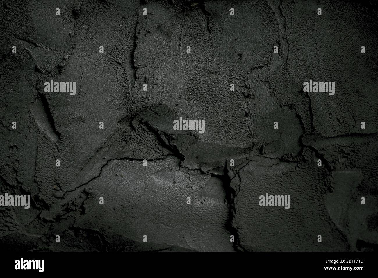 Dark wall in cement mortar. Cracked exterior texture background Stock Photo