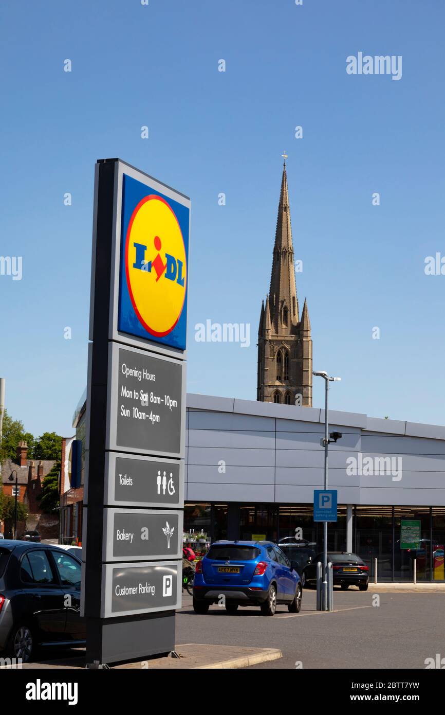 Lidl supermarket car park and sign with St Wulframs church spire behind. Grantham, Lincolnshire, England. May 2020 Stock Photo