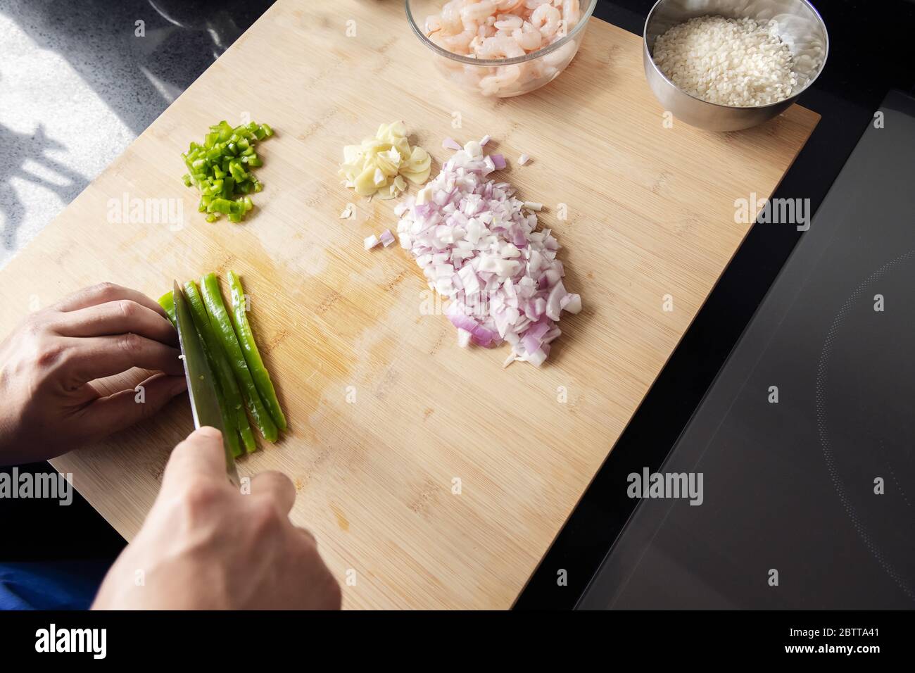 top view of hands cutting vegetables on the cutting board in the kitchen, concept of healthy eating Stock Photo