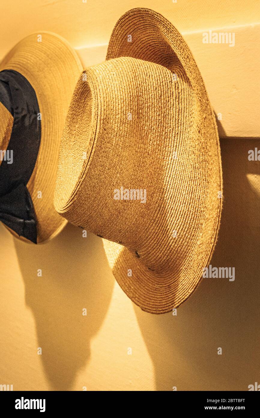Man's straw hat hanging in a closet Stock Photo