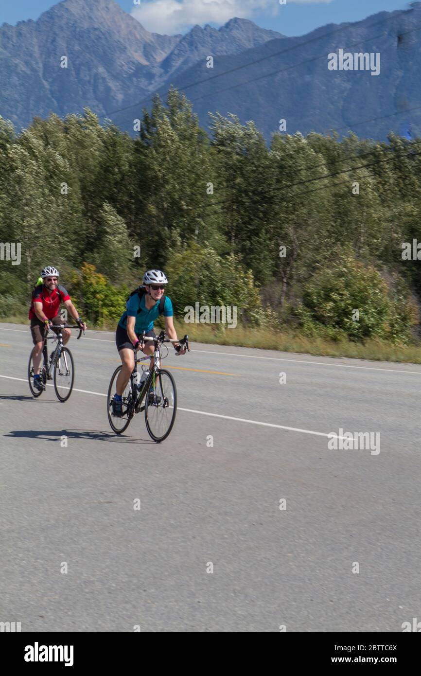 Scenic Bike Race, 2 riders, in full racing gear and uniform. Race goes ...