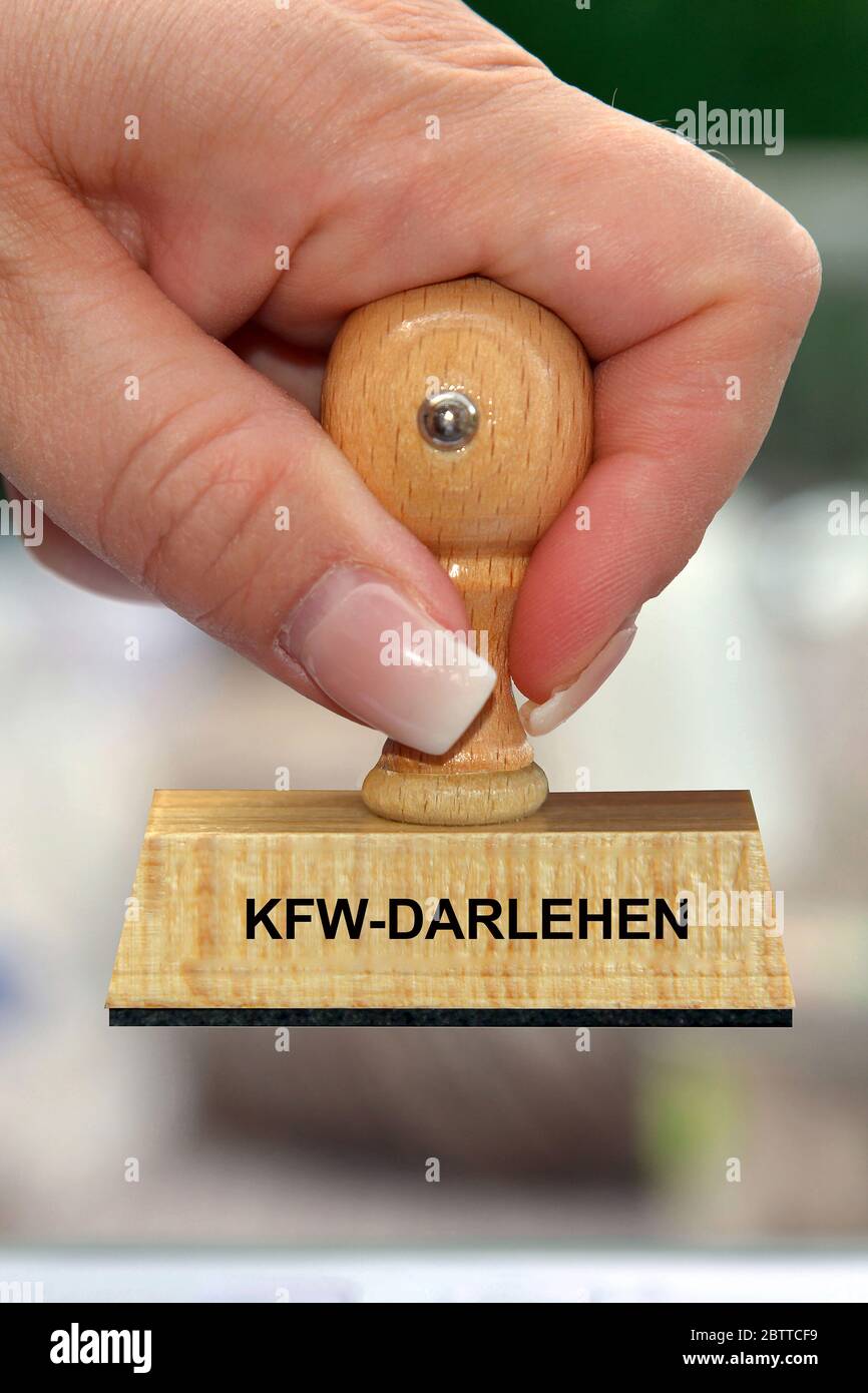 Hand mit Stempel, Frauenhand, Aufschrift: KFW-Darlehen Stock Photo
