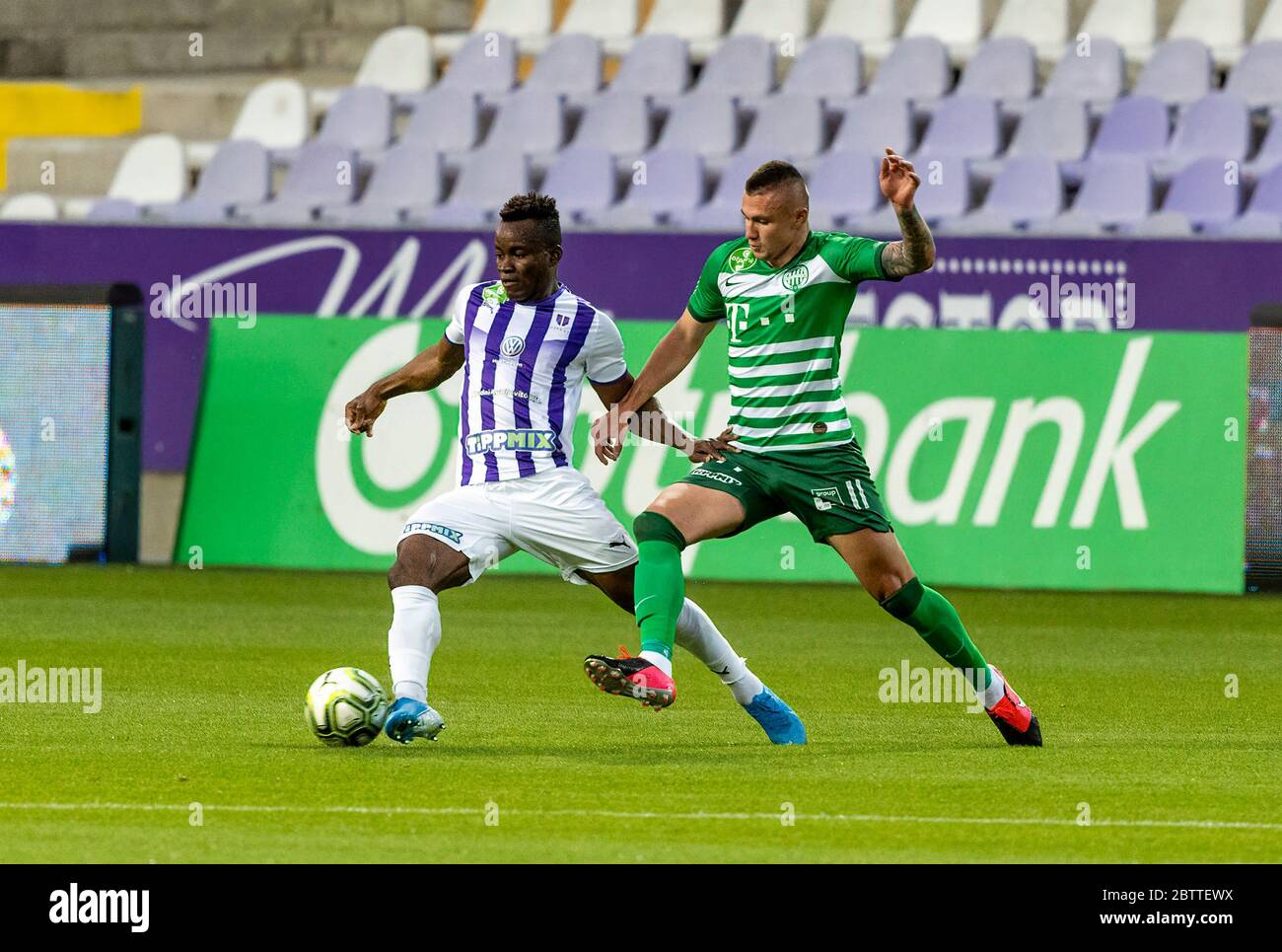 BUDAPEST, HUNGARY - MAY 4: Ihor Kharatin of Ferencvarosi TC #14 blocks the  shot from Vincent Onovo of Ujpest FC (l) before Tokmac Chol Nguen of Ferencvarosi  TC #92 during the Hungarian