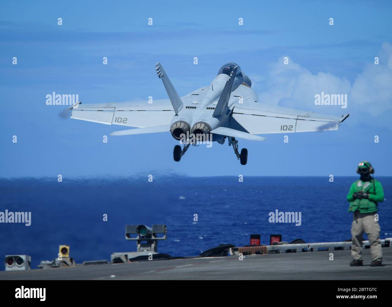 A U.S. Navy F/A-18F Super Hornet fighter aircraft, assigned to the Black Knights of VFA 154, launches from the flight deck of the Nimitz-class aircraft carrier USS Theodore Roosevelt May 26, 2020 in the Philippine Sea. The COVID-negative crew returned from quarantine and the ship has continued their scheduled deployment to the Indo-Pacific. Stock Photo