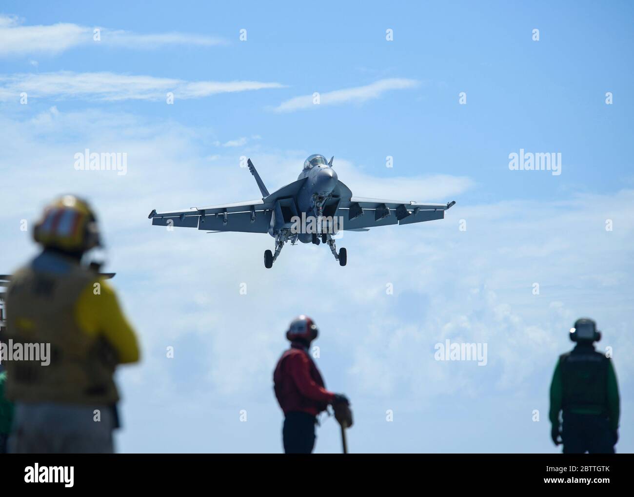 A U.S. Navy F/A-18F Super Hornet fighter aircraft, assigned to the Black Knights of VFA 154, launches from the flight deck of the Nimitz-class aircraft carrier USS Theodore Roosevelt May 26, 2020 in the Philippine Sea. The COVID-negative crew returned from quarantine and the ship has continued their scheduled deployment to the Indo-Pacific. Stock Photo