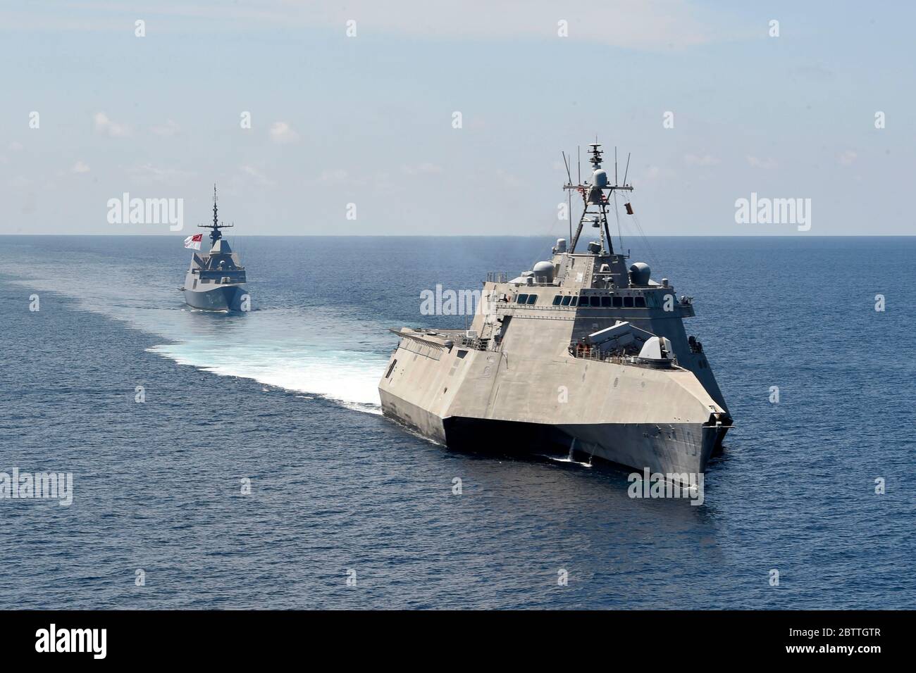 The U.S. Navy Independence-variant littoral combat ship USS Gabrielle Giffords patrols alongside the Republic of Singapore Navy Formidable-class multi-role stealth frigate RSS Steadfast, rear, in international waters May 25, 2020 in the South China Sea. Stock Photo