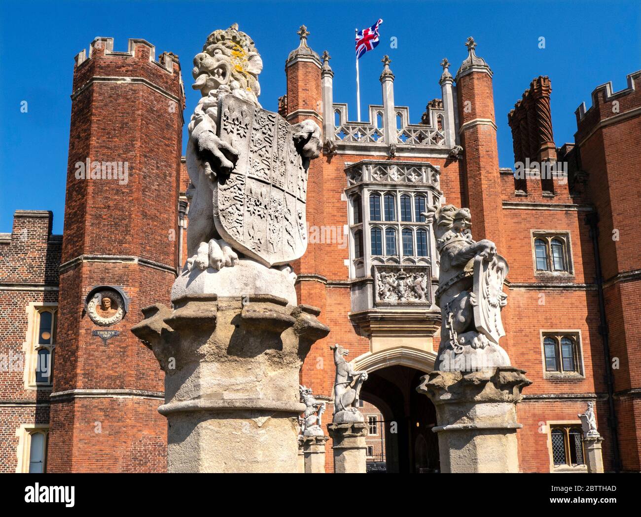 Hampton Court Palace facade with Union Jack Flag flying, a royal Tudor palace in the London Borough of Richmond upon Thames Greater London Surrey UK Stock Photo