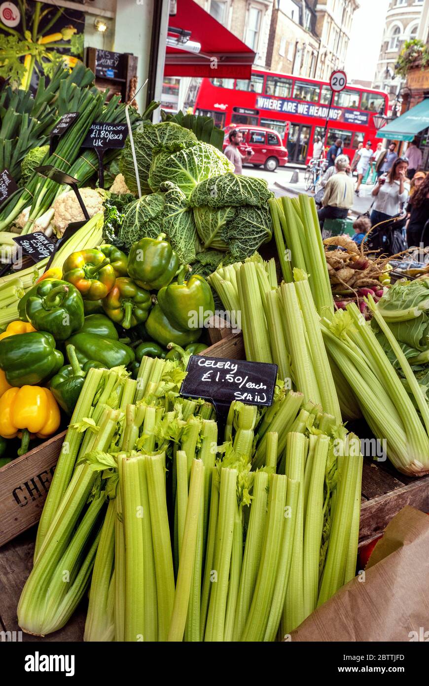 BOROUGH MARKET CELERY SPAIN with Valley Farm Shop stall with farmers attractive rustic green leaf cabbage cabbages vegetable display, red London bus and taxi in background, Southwark London UK Stock Photo