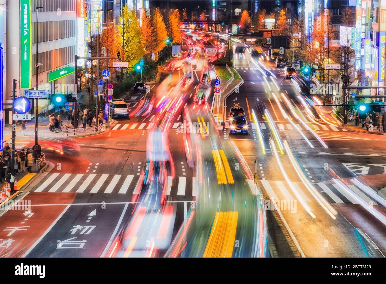 Tokyo, Japan 31 Dec 2019: Shinjuku Shibuya road crossing at night with motor vehicle traffic lights blurred on a road. Stock Photo