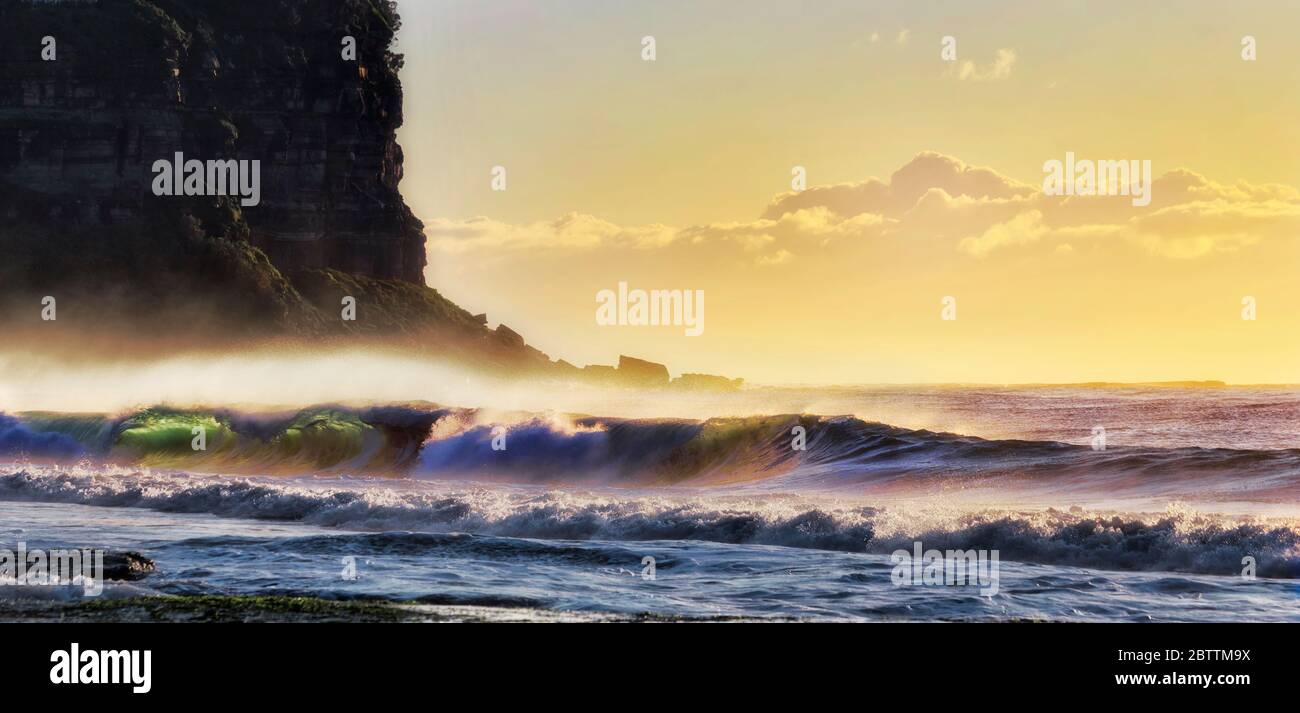 Massive cliff of Bungan head facing Pacific ocean and stormy waves surfing to Northern beach of Sydney. Stock Photo
