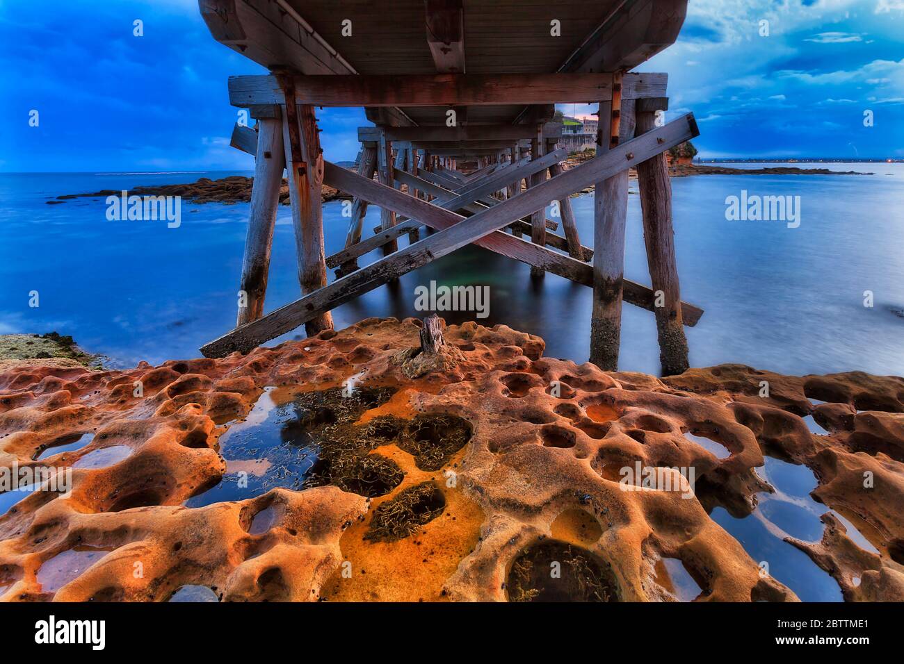 Underneath of timber boardwalk and bridge to Bare island in Sydney